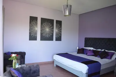 a bedroom with a bed and two pictures on the wall at Villa Loanaelle in Marrakech