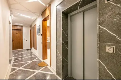 a hallway with a tile floor and a glass door at Luxury apartment in center Of Marrakech City in Marrakech
