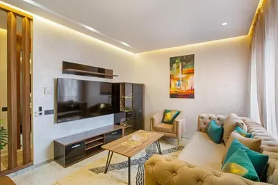 a living room with a couch and a flat screen tv at Luxury apartment in center Of Marrakech City in Marrakech