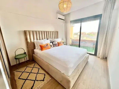 a bedroom with a large bed and a large window at Cozy&Elegant apartment/pool/city center/Gueliz in Marrakech