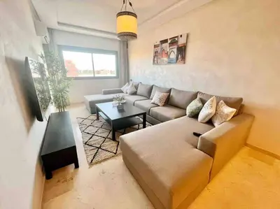 a living room with a couch and a table at Cozy&Elegant apartment/pool/city center/Gueliz in Marrakech