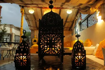 two black lanterns on a table in a room at Riad Les Gazelles D'Orient Marrakech in Marrakech