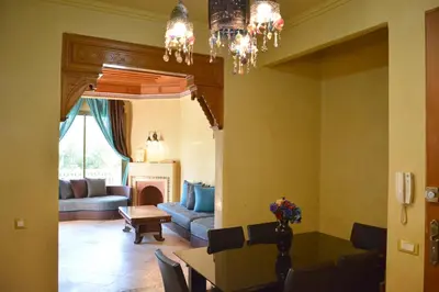 a living room with a table and a couch at Palmeraie Stay - Pool & Lake in Marrakech