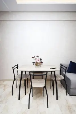 a dining room table with chairs and a couch at Appartement Marrakech Hivernage. in Marrakech