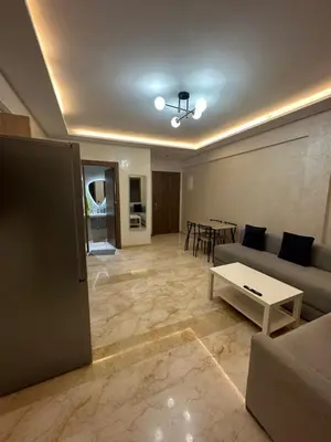a living room with a couch and a table at Appartement Marrakech Hivernage. in Marrakech