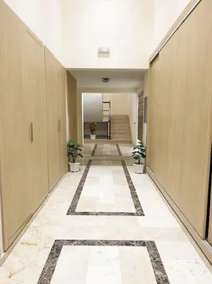 a hallway of an office with two plants in it at Appartement Marrakech Hivernage. in Marrakech