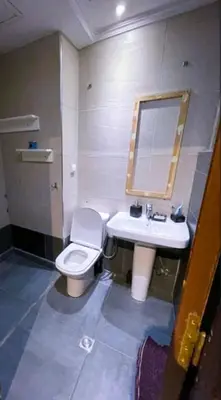 a bathroom with a white toilet and a sink at Gueliz budget Stay in Marrakech