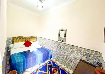 a bedroom with a bed and a mosaic wall at Sun Hostel in Marrakech
