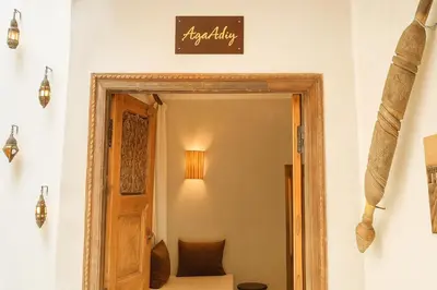 a room with a door and a sign on the wall at Riad Belikoss Pool & SPA in Marrakech