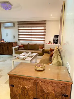 a living room with a couch and a table at Pierre précieuse au cœur de l'hivernage J40 in Marrakech