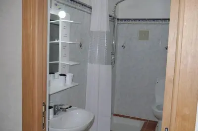 a bathroom with a shower and a sink and a toilet at studio, à proximité de la gare in Marrakech