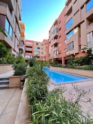 a swimming pool in an apartment complex with buildings at Bel Appartement à Marrakech en Résidence avec Piscine - Fibre & Netflix in Marrakech