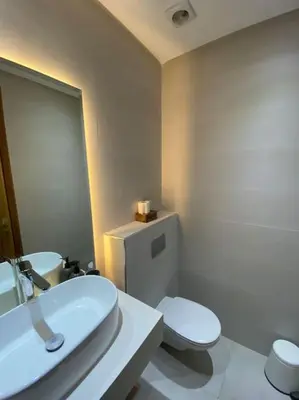 a white bathroom with a toilet and a sink at NEW appartement in palmeraie in Marrakech