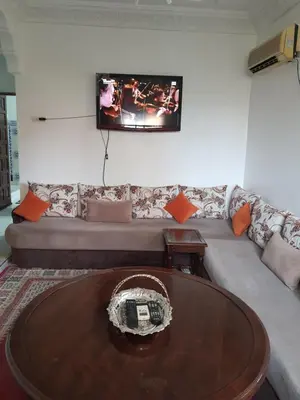 a living room with a couch and a tv on the wall at Marrakech in Marrakech