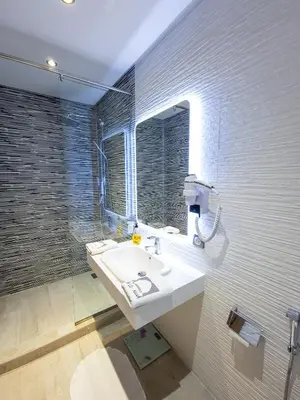 a bathroom with a sink and a mirror at Villa HAW Marrakech in Marrakech