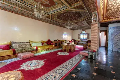 a living room with a couch and a table at Villa Amerchiche in Marrakech