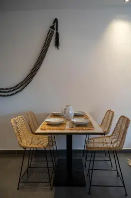 a table with two chairs at L'appart by Louhou Collection in Marrakech