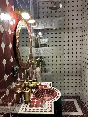 a bathroom with a sink and a mirror at Riad Tesnime in Marrakech