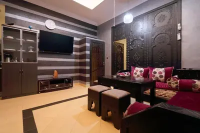 a living room with a couch and a tv at Appartement centre de Marrakech in Marrakech