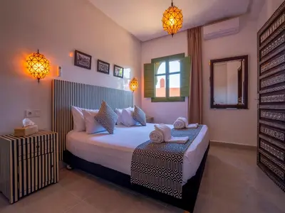 a bedroom with a bed with two towels on it at Riad Dar Sido in Marrakech