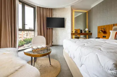 a hotel room with a large bed and a chair at Fashion Boutique Hotel in Marrakech
