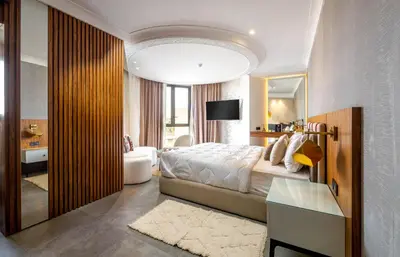 a bedroom with a large bed and a mirror at Fashion Boutique Hotel in Marrakech