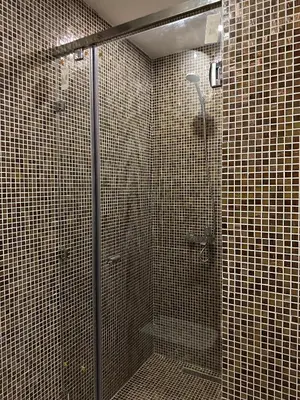a bathroom with a shower with tiled walls at Cosy studio au centre de Marrakech Netflix in Marrakech