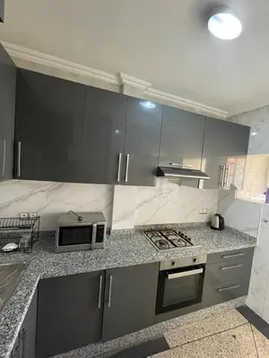 a kitchen with a stove and a microwave on a counter at Luxury Apartment in Marrakesh in Marrakech