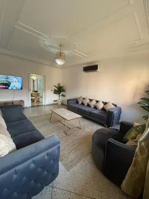 a living room with two blue couches and a table at Luxury Apartment in Marrakesh in Marrakech