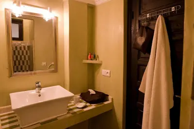 a bathroom with a sink and a mirror at Riad Signature in Marrakech