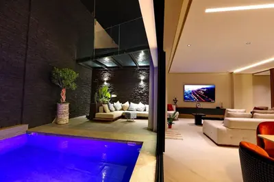 a living room with a pool in the middle at Duplex de luxe, piscine sauna in Marrakech