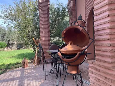 a large copper fire hydrant sitting on a patio at Au Riad de la Palmeraie - Marrakech in Marrakech