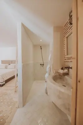 a large bathroom with a tub and a bed at Riad Casa Kasbah in Marrakech