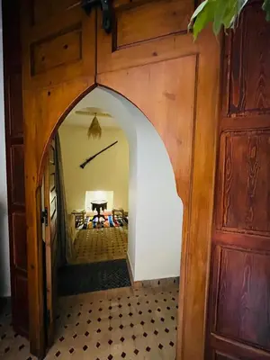 an archway leading into a room with a table at Riad Rayan in Marrakech