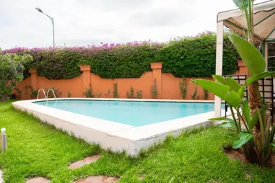 a swimming pool in the yard of a house at villa 5 chambres pour famille avec piscine & parking in Marrakech