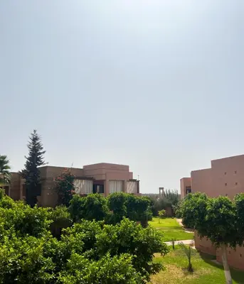 a view of the building from the garden at Luminous apartment with pool view in Marrakech
