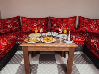 a table with plates of food on a couch at Dar Nourdha in Marrakech