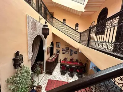 a hallway with a staircase and a living room at Riad Lahbiba in Marrakech
