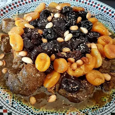 a plate of food with meat and nuts on it at Riad Lahbiba in Marrakech