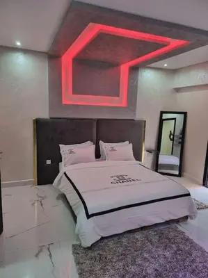 a bedroom with a bed with a red light above it at Kech vacations Friendly! Luxury 2 bed apartment in Marrakech