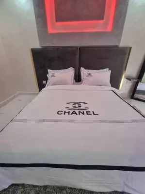 a bed in a room with a sign on it at Kech vacations Friendly! Luxury 2 bed apartment in Marrakech