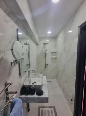 a bathroom with a sink and a mirror at Kech vacations Friendly! Luxury 2 bed apartment in Marrakech