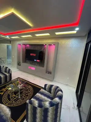 a lobby with two chairs and a table and a tv at Kech vacations Friendly! Luxury 2 bed apartment in Marrakech