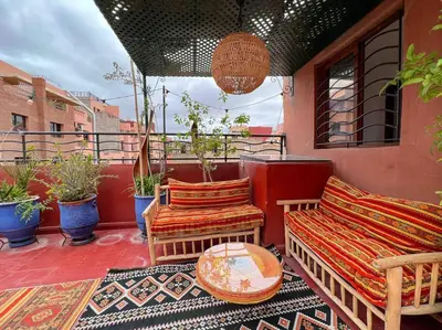 a patio with two chairs and a table on a balcony at Appartamento nel quartiere Gueliz , Marrakech in Marrakech