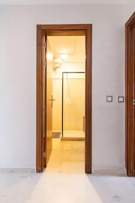 an empty room with a door and a hallway at Appartement pour les familles , superbe vue sur la piscine in Marrakech