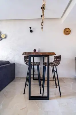 a table with two chairs in a room at Appartement pour les familles , superbe vue sur la piscine in Marrakech