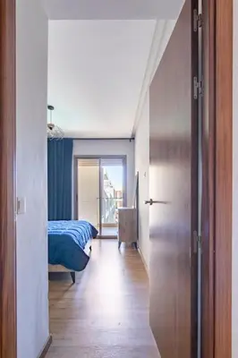 a room with a bedroom with a bed and a door at Appartement pour les familles , superbe vue sur la piscine in Marrakech