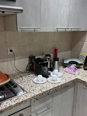 a kitchen counter with three cups and plates on it at Bel appartement à louer à Marrakech targa in Marrakech