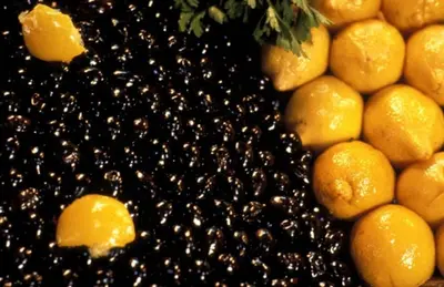 a pile of blackberries next to a pile of oranges at Riad Dar Rania Marrakech Médina Jemaa El Fna in Marrakech