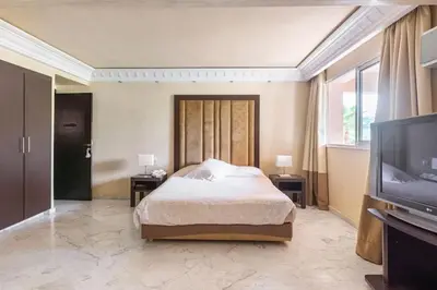 a bedroom with a bed and a flat screen tv at Somptueux Duplex au coeur de l'Hivernage in Marrakech